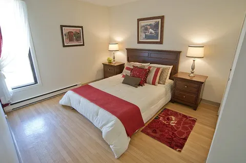 Bedroom with a bed beside a window.
