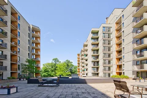 Residence balconies overlooking a paved courtyard.