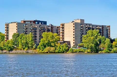 Residence buildings seen across the river.