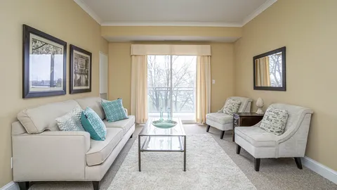 Sitting area with a sofa, two armchairs and a glass table