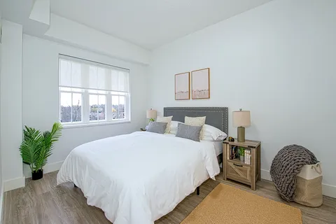 Bedroom with a double bed, bedside tables and a window.
