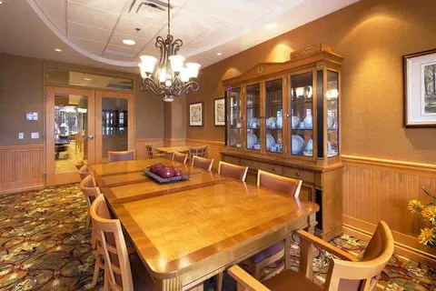 Private dining room with a long wooden table and a china cabinet.