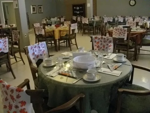 Dining room with round tables set for a meal.