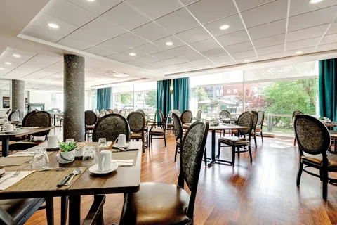 Dining room with set tables and upholstered chairs