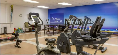 Exercise room with stationary machines, weights and a table-tennis table