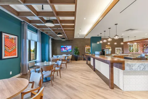 Cafe counter and seating beside large windows