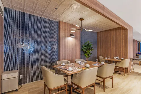 Dining room with set tables beneath pendant lights