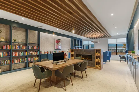 Library and computer area with bookshelves and worktables