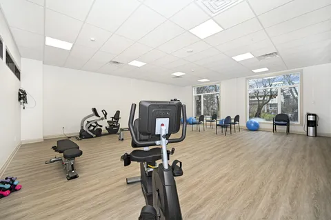Fitness room with exercise machines and large windows