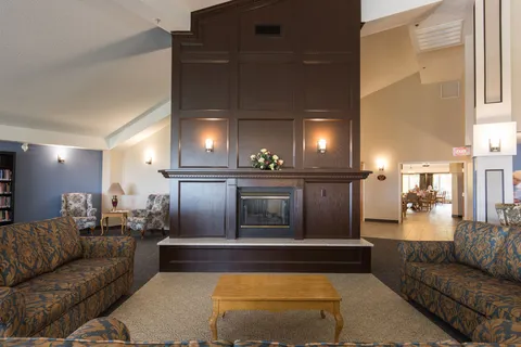 Lounge with sofas and a fireplace feature wall.