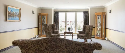 Lounge seating beside large windows.