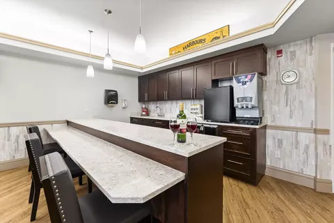 Bar counter with stools, a coffee machine and pendant lights