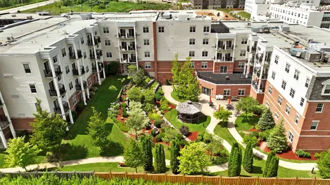 Aerial view of the residence buildings around a landscaped courtyard with a gazebo
