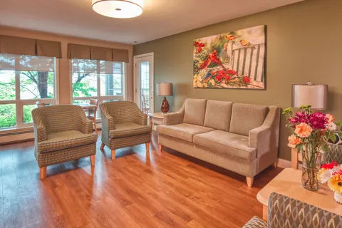 Sitting area with sofas and armchairs beside large windows