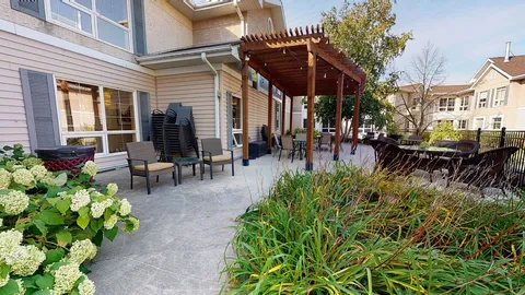 Courtyard patio with a pergola, seating and planting beds