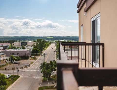 Balcony beside the residence overlooking a street and nearby buildings