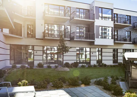 Residence balconies and glazed ground floor overlooking a landscaped courtyard