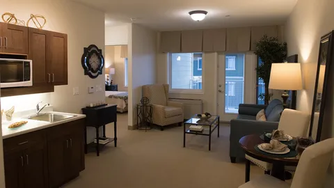 Suite kitchenette and seating area beside windows.