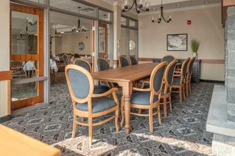 Dining room with a long wooden table and blue upholstered chairs