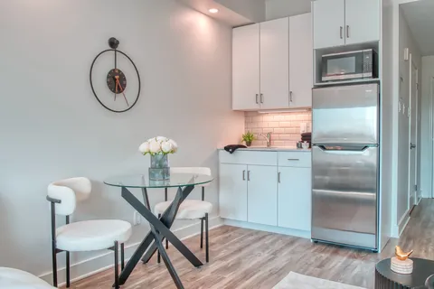 Suite kitchenette with a glass dining table and chairs