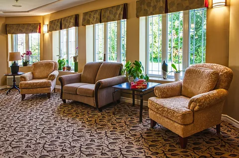 Sunroom seating beside floor-to-ceiling windows