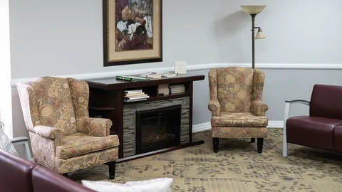 Lounge seating beside a fireplace.
