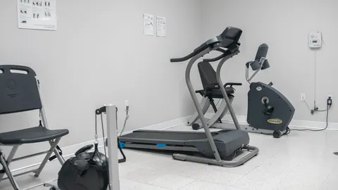 Exercise area with stationary equipment.