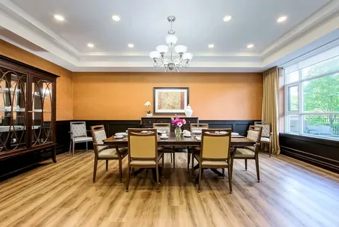 Room with a long dining table and upholstered chairs