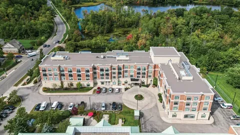Aerial view of the residence, parking areas and surrounding trees