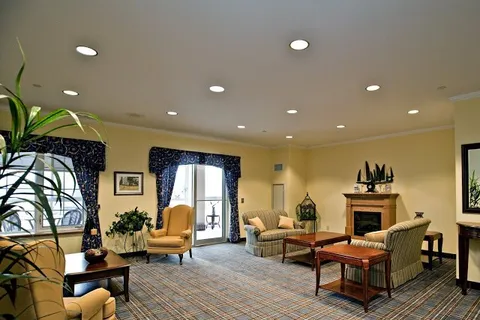 Room with armchairs, sofas, a fireplace and doors to balconies