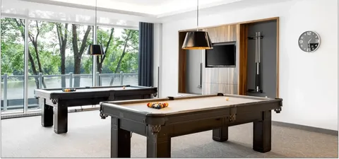 Billiards room with a pool table and television