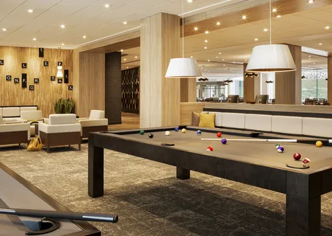 Billiards room with a pool table and lounge seating.