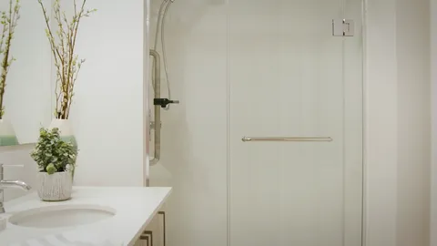 Suite bathroom with a vanity and shower area.