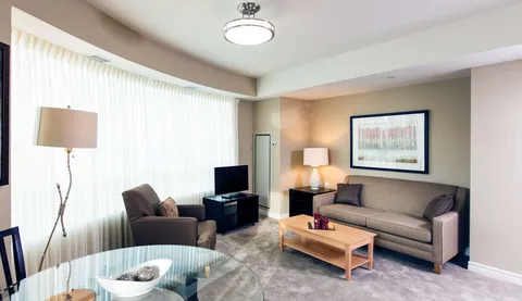 Sitting area with a sofa, armchair, coffee table and a television
