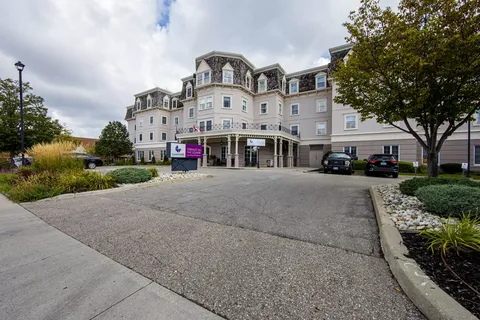 Residence building with a covered front entrance beside a driveway