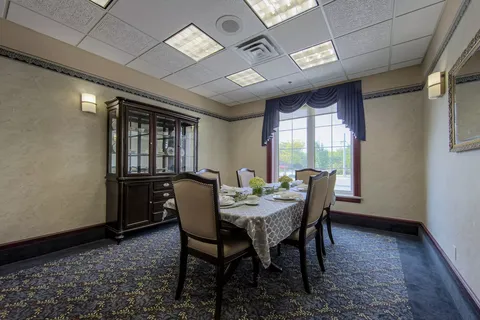 Small dining room with a set table and a glass-fronted cabinet