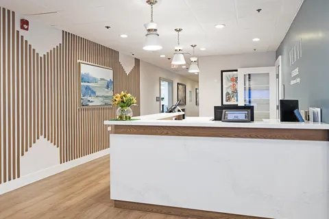 Reception desk beside a wood-panelled entrance hall