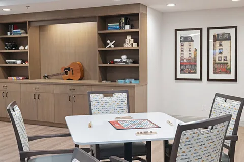 Games table beside display shelves and cupboards