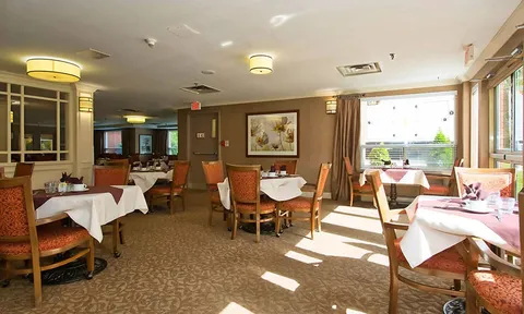 Dining room with set tables beside large windows