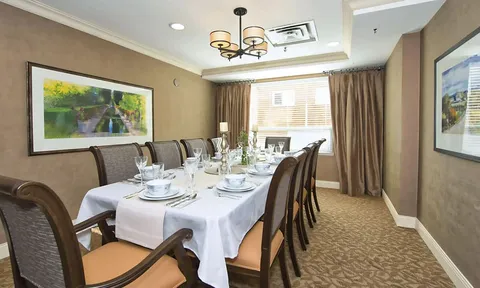 Private dining room with a long table and upholstered chairs