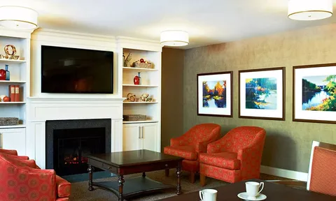 Lounge with red armchairs and a fireplace