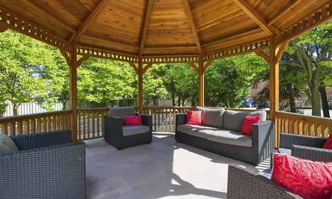 Wooden gazebo with cushioned outdoor seating