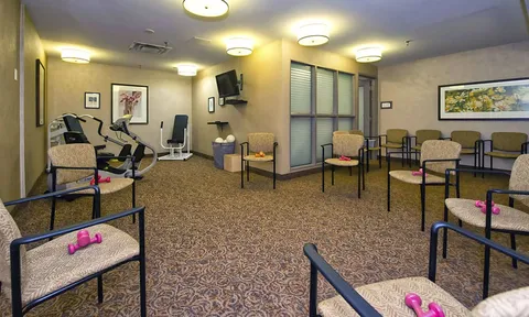 Fitness room with exercise bicycles and chairs
