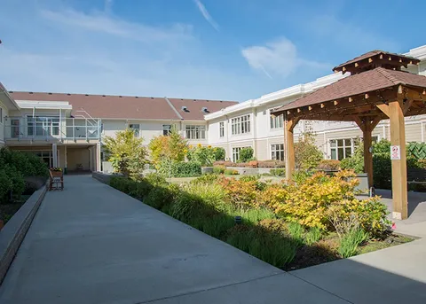 Residence courtyard with landscaped beds and a covered entrance.
