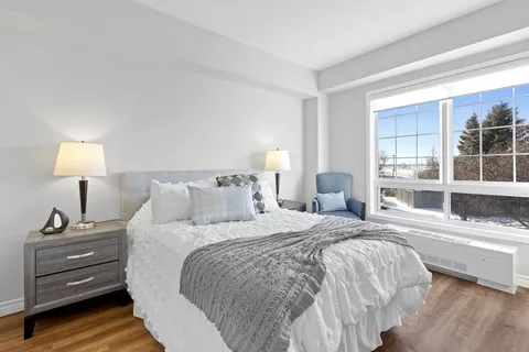 Bedroom with a double bed and large windows