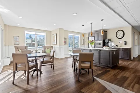 Dining room with round tables, chairs and a wood counter