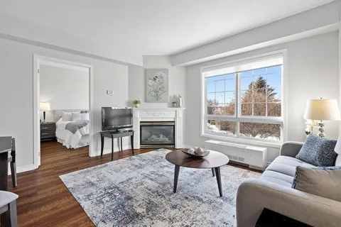 Sitting area with a sofa, fireplace and large windows