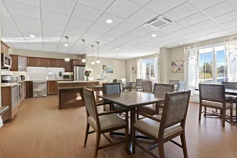 Dining area with tables, chairs and a wood kitchen counter