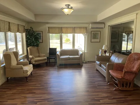 Room with sofas, armchairs and wide windows