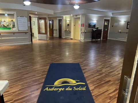Entrance lobby with wooden flooring, reception counter and blue doormat